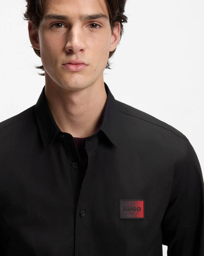 Model wearing HUGO Mens Emero Mens Relaxed-Fit Shirt in Stretch-Cotton Canvas in Black 001 - close up